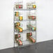 A Regency chrome wire shelving unit with can racks on it.