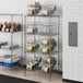Regency chrome wire shelves with can racks holding food items.