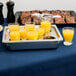 A tray of glasses with orange juice on a table.