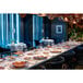 A long table set with Villeroy & Boch Copper Glow porcelain deep plates with copper rims and white wells.