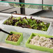 A white G.E.T. Enterprises Bugambilia straight-sided rectangular salad bowl filled with salad on a salad bar counter.