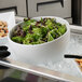 A G.E.T. Enterprises white resin-coated aluminum Texas round bowl with salad on ice.