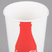 A white paper cup with a red Coca-Cola bottle design.