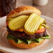 Kosher Dill Pickle Sandwich Slices on a burger on a plate.