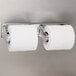 A San Jamar chrome double roll toilet paper dispenser with two rolls of toilet paper.