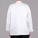 The back view of a white Chef Revival long sleeve chef jacket.