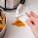 A hand using a Plenty paper towel to wipe a counter.