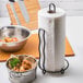A roll of Plenty Ultra Premium paper towels on a table next to a bowl of food.