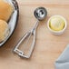 A metal scoop of bread on a table.