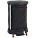 A Rubbermaid black linen hamper on wheels with a black bag on a metal frame.