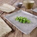 A rectangular sandstone melamine tray with a plant on it.