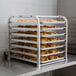 a tray of croissants on a metal rack
