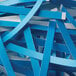 A pile of blue and white paper strips shredded by a Swingline CS25-44 strip-cut shredder.