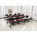 An Iceberg mahogany laminate training table with black legs in a room with tables and chairs.