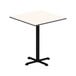 A white square table top with a black base.