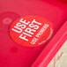 a red container with a round sticker