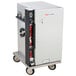 A grey and black Metro TC90S heated holding cabinet on a cart with a red handle.