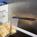 A Cecilware fryer basket with food in it.