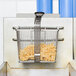 A Cecilware fryer basket with french fries inside.