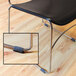 A black sled base chair with Master Caster felt floor protectors on the metal legs.