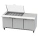 A Beverage-Air stainless steel refrigerated sandwich prep table with three doors open on a counter.