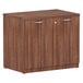 A Alera Valencia Modern Walnut storage cabinet with two doors.