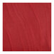 A close-up of a mahogany wood grain on a red surface.