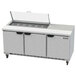 A Beverage-Air stainless steel refrigerated sandwich prep table with three doors and a lid open.