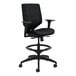 A black HON Solve Series office stool with armrests.