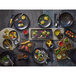 An Ananti walnut wood square tray and stand with food on it.
