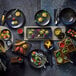 A table with Playground Sea round coupe plates and food on it.