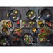 A Playground Ananti wooden tray on a table with food.