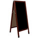 A cherry wood A-frame sign board with a black marker board.