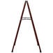 A wooden A-Frame sign with a cherry wood and metal frame.