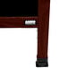 The black and brown wood A-frame of an Aarco cherry sign board on a table.