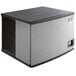 A black and grey rectangular Manitowoc air cooled ice machine.