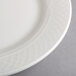 A close-up of a Homer Laughlin Kensington Ameriwhite bright white china plate with a pattern.