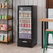 A black refrigerated glass door merchandiser with LED lighting, displaying various beverages and products inside.