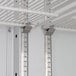 Metal shelves with metal rods inside a Beverage-Air Marketeer Series glass door refrigerator.