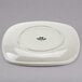 A white Tuxton square china plate.