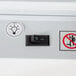 A close up of the switch on a white Beverage-Air refrigerated glass door.