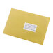 A yellow envelope with a white Avery rectangle label on it.