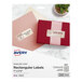 A package of Avery rectangle pearlized ivory labels with a white and pink box.