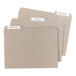 Three white file folders with Avery Rectangle Write-On File Folder Labels on them.