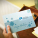 A hand placing Avery matte clear address labels on a blue envelope.