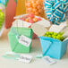 A group of Avery white strung marking tags on boxes of blue and white striped candies.