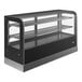 A black Vollrath Cubed Countertop Display Case with glass doors on a bakery counter.
