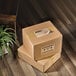 Two boxes of Avery Kraft Brown Shipping Labels on a wood floor.