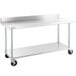 A Regency stainless steel work table with casters.