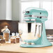 Aqua Sky KitchenAid mixer on a counter with a bowl.